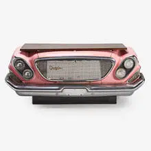 Designer illuminated bar/console table, constructed from the grill, headlights, and front bumper of a 1962 Chrysler Newport by Contemporary, sold Sep 2019