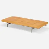 PK 80 daybed by Poul Kjærholm, 1957 / 2007, stainless steel, lacquered wood, leather upholstery, rubber, sold Sep 2024