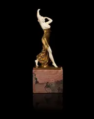 'The Swirling Dress' a Gilt-Bronze and Carved Ivory Study by Ferdinand Preiss, SIGNED IN CAST 'F.PREISS'; CIRCA 1920, modelled as a bare-breasted dancer, raised off a marble plinth