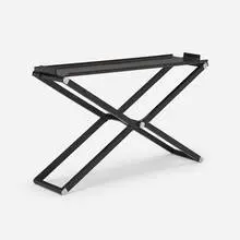 Pippa console by Rena Dumas and Peter Coles, c. 1985, ebonized pearwood, nickel-plated steel, sold Jun 2024