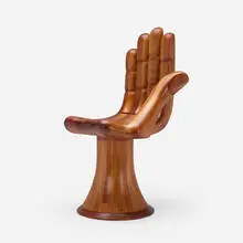 Hand chair by Pedro Friedeberg, c. 1965, stack-laminated and stained mahogany, sold Mar 2024