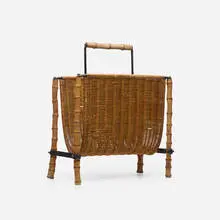 Magazine rack by Jacques Adnet, c. 1940, rattan, iron, bamboo, brass, sold Mar 2024