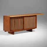 Special Double Sliding Door cabinet by George Nakashima, 1961, American black walnut, pandanus cloth, oak, sold Dec 2023