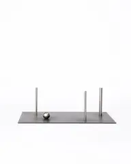 Ohne Titel by Ernst Hermanns, 1994, Edelstahl und schwarze Eisenplatte, sold Sep 2026