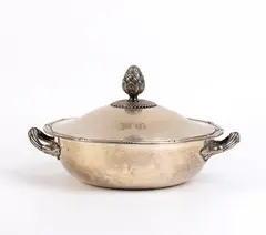 Solid silver Austrian entrée dish by Josef Carl Klinkosch, 1867, circular in shape with a snap-on lid. The lid features a handle representing a rich cluster of leaves and a flower, offered Feb 2026