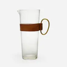 Pitcher by Carl Auböck III, c. 1955, glass, leather, brass, sold Aug 2023