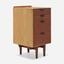 Cabinet by Finn Juhl, c. 1951, walnut, maple, enameled brass, sold Aug 2023