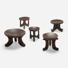 Collection of five stools by African, carved wood with applied dirt surface, sold Aug 2023