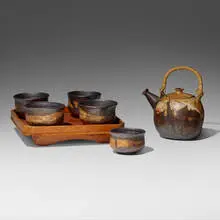 Tea service by Toshiko Takaezu, c. 1965, glazed stoneware, bamboo, cane, lacquered wood, sold Aug 2023