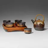 Tea service by Toshiko Takaezu, c. 1965, glazed stoneware, bamboo, cane, lacquered wood, sold Aug 2023