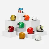 Collection of ten motorcycle helmets by Modern, c. 1975-2013, lacquered fiberglass, lacquered composite, acrylic, leather, chrome-plated brass, chrome-plated steel, sold Aug 2023