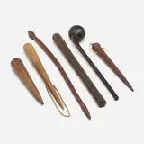 Collection of six clubs by African and Asian, carved and stained wood, leather, rope, sold Jun 2023