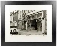 Titled Black Cat, edition 16/25. Signed in ink in the lower right corner. Depicts a by Samuel Cherry, photograph of a street scene during the early 20th century. Dimensions: Visible, sold Sep 2026