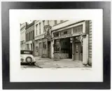 Titled Black Cat, edition 16/25. Signed in ink in the lower right corner. Depicts a by Samuel Cherry, photograph of a street scene during the early 20th century. Dimensions: Visible, sold Sep 2026