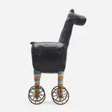 Beastie with wheels by Dennis Pearson, 1986, lacquered fiberglass, painted wood, enameled steel, textile, rubber, sold May 2023