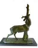 Jeune cerf frottant ses bois près d'un tronc by Amédée Charles Henry Cham, Epreuve en bronze à patine brun-vert, sold Nov 2025