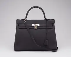 A BLACK TOGO LEATHER RETOURNÉ KELLY 35 WITH PALLADIUM HARDWARE by Hermès, A BLACK TOGO LEATHER RETOURNÉ KELLY 35 WITH PALLADIUM HARDWARE, sold Jan 2026