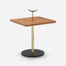 Occasional table by Milo Baughman, c. 1956, walnut, brass, enameled steel, enameled brass, sold May 2023