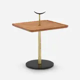 Occasional table by Milo Baughman, c. 1956, walnut, brass, enameled steel, enameled brass, sold May 2023