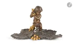 Encrier à décor d'un putto, de grappes de raisin et feuilles de vigne by Charles Cumberworth, Epreuve en bronze patiné et doré Signé, sold May 2026