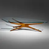 Tri-symmetric coffee table by Vladimir Kagan, c. 1955, walnut, glass, sold May 2023