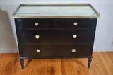 Commode. Black lacquer with gilded by Commode, bronze fittings and mirrored top. 20 3/8 D x 35 H x 42 1/2 W in. Four drawers. P, offered Oct 2020