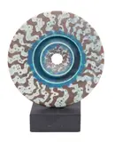 A disc form stoneware sculpture by Peter Beard, sculpture, offered Oct 2025