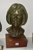 A BRONZED COMPOSITE BUST OF A FEMALE MOUNTED ON A WOODEN PLINTH with a textured bronzed by Len Hardy, sculpture, sold Jun 2025