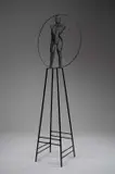 Nude Figure within a Wheel Black wire mesh on a metal stand 93 by David Begbie, sculpture, sold Dec 2025