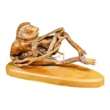 A wooden sculpture of a reclining frog-like figure by Pierre Decorse, sculpture, sold Jan 2026