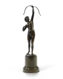 A patinated bronze figure of Diana standing nude with her by Percimer Rudolfi, bronze, sold Nov 2025