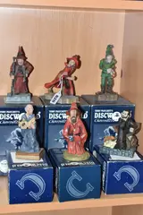 comprising Ridcully DW61, Rincewind Running DW86 (missing by Six Boxed Clarecraft Discworld Sculptures, sculpture, sold Mar 2025