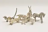 to include a hare, two phesants, a horse, three dashunds by Assorted White Metal Figurines, sculpture, sold Feb 2025