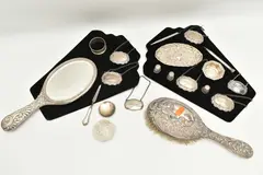 to include a vanity hair brush and hand held mirror, embossed with a by Assorted Silver Items, pencil, sold Jan 2025