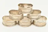 each of a D shape with engine turned pattern and vacant cartouches, four by Six Silver Napkin Rings, sculpture, sold Nov 2024
