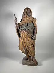Le gardien du harem by Friedrich Goldscheider, Epreuve en terre cuite polychromée (petites égrenures, restauration à un pouce), le fusil, sold Apr 2024