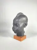 Buste d'enfant éthiopien by Riccardo Scarpa, Terre cuite à patine noire signée, sold Oct 2023