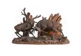 A large black forest carved wood group of fighting stags, circa 1900 by Ernst Heisl, sculpture, sold May 2025