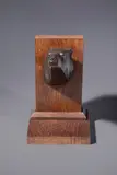 Tête d’ours by Armand Petersen, Epreuve en bronze à patine brune reposant sur un socle en chêne, sold Oct 2025
