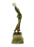 An Art Deco bronze and ivory figure of a lady wearing a stylish by Josef Lorenzl, bronze and ivory, sold Mar 2025