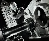 Lathe Operator At Marweight, Burnley, Melbourne by Wolfgang Sievers, 1968, silver gelatin photograph on card, sold Oct 2022