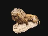 Lion rugissant sur socle en pierre by Thomas François Cartier, Bronze patine médaille signée sur la terrasse, sold Jun 2025