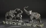 Deux éléphants et leur éléphanteau barrissant by Michel Decoux, Bronze à patine brune, terrasse plaquée de marbre noir et marbre vert de mer, sold Jun 2025