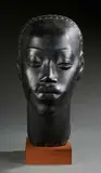 Tête de femme africaine by Riccardo Scarpa, Épreuve en terre cuite patinée noir, sold May 2023