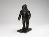 Hunter Holding a Rifle by Joanasee Kakkik, stone sculpture, sold Aug 2024