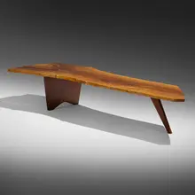 Slab coffee table by George Nakashima, c. 1957, English walnut, rosewood, sold Mar 2023