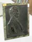 Bas relief portrait plaque of Abraham Lincoln by Victor David Brenner, marble and bronze easel stand, sold Sep 2022