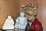 PORCELAIN AND RESIN BUDDHA FIGURES, including a wooden buddha with one raised by Six Modern Wooden, sculpture, sold Jun 2022