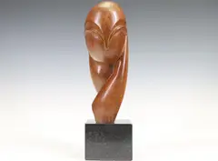 Mademoiselle Pogany III by Constantin Brancusi, Bronze sculpture of an abstract bust mounted to a granite plinth, sold Jun 2023