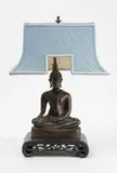 Bouddha assis en virasana faisant le geste Bhumispara Mudra. Vêtu de sa robe monastique utasanga, le crâne orné de la protubérance ushnisha by Période Ayutthaya Thailande, Bronze patiné brun, sold Jul 2024